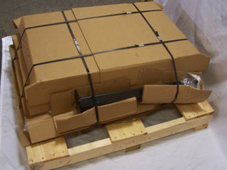 Cardboard boxes strapped on wooden pallet